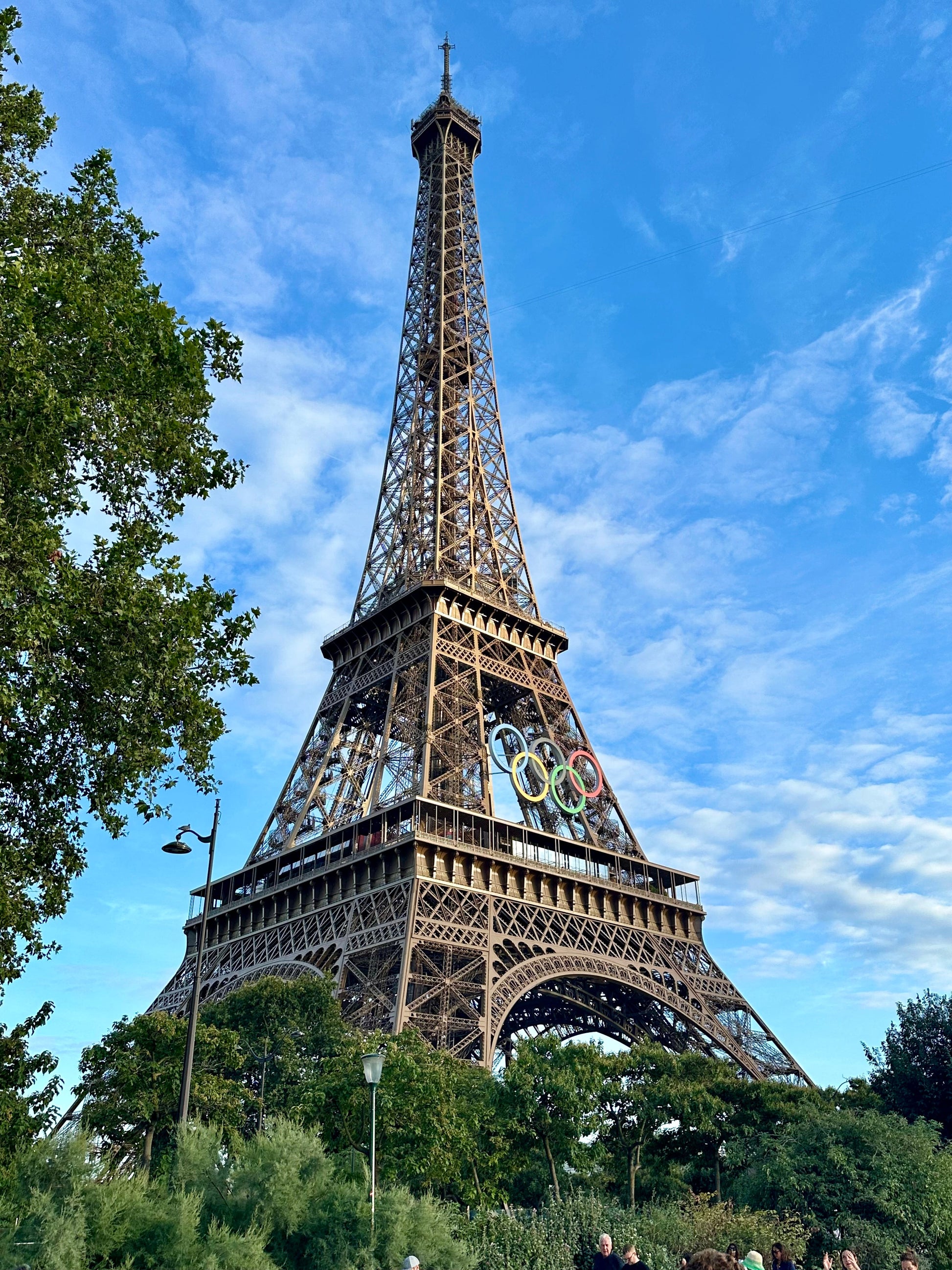 Eiffel Tower with Olympic rings under a blue sky, representing iconic Paris landmarks featured in the Paris & London Travel Guides bundle.
